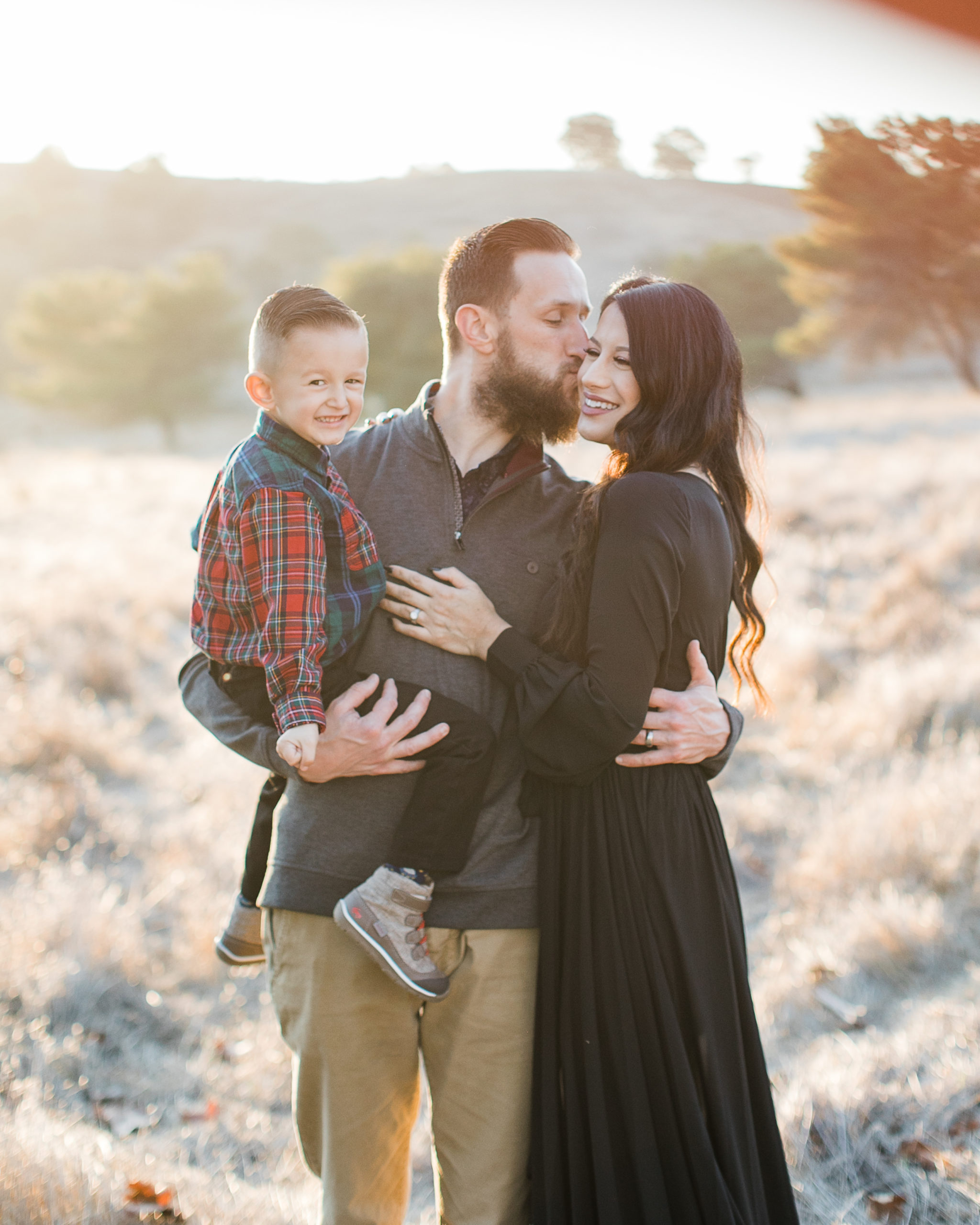 a family laughs together during family photos at Santa Teresa Park