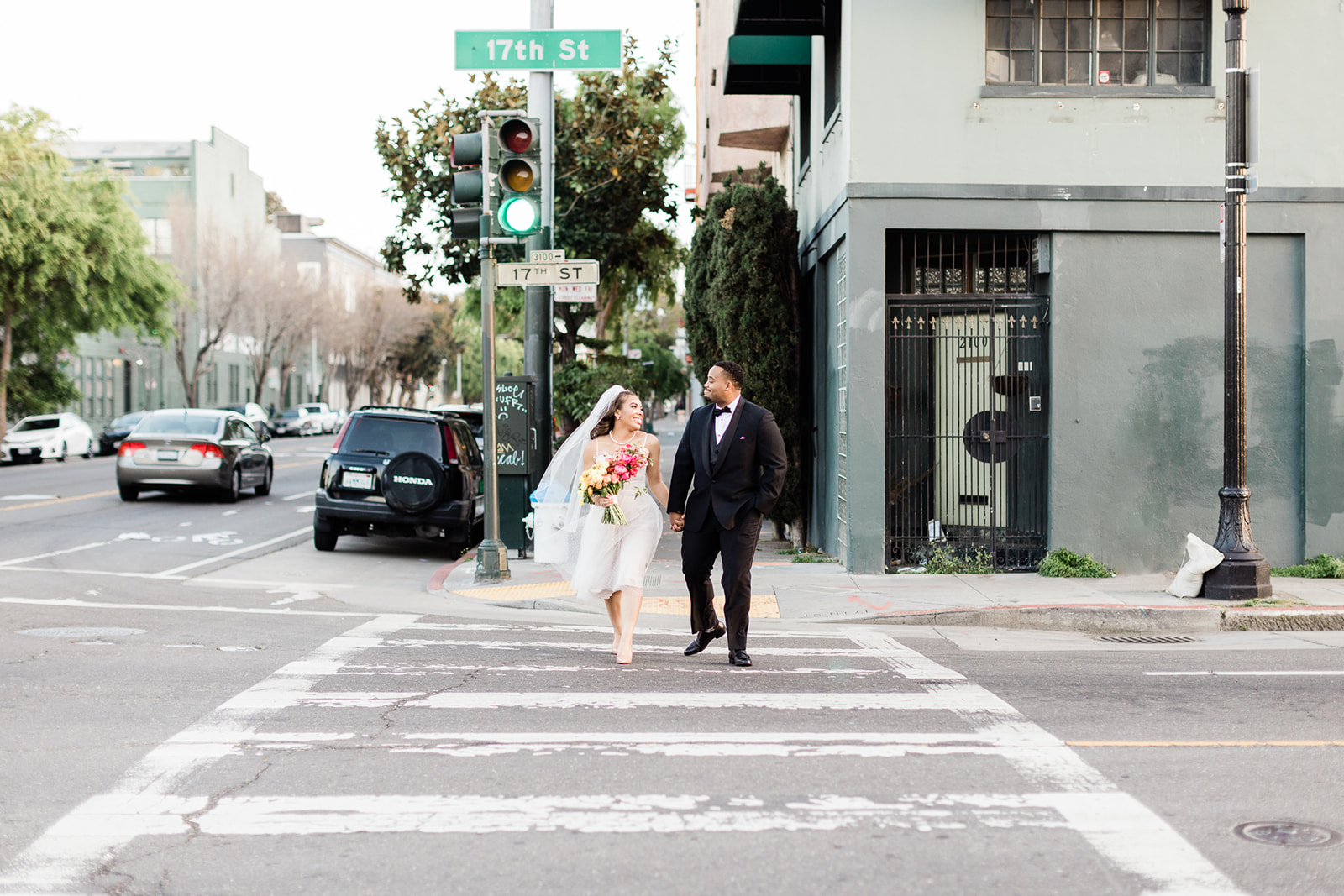 a couple walks across the street after their wedding at Stable Cafe in San Francisco